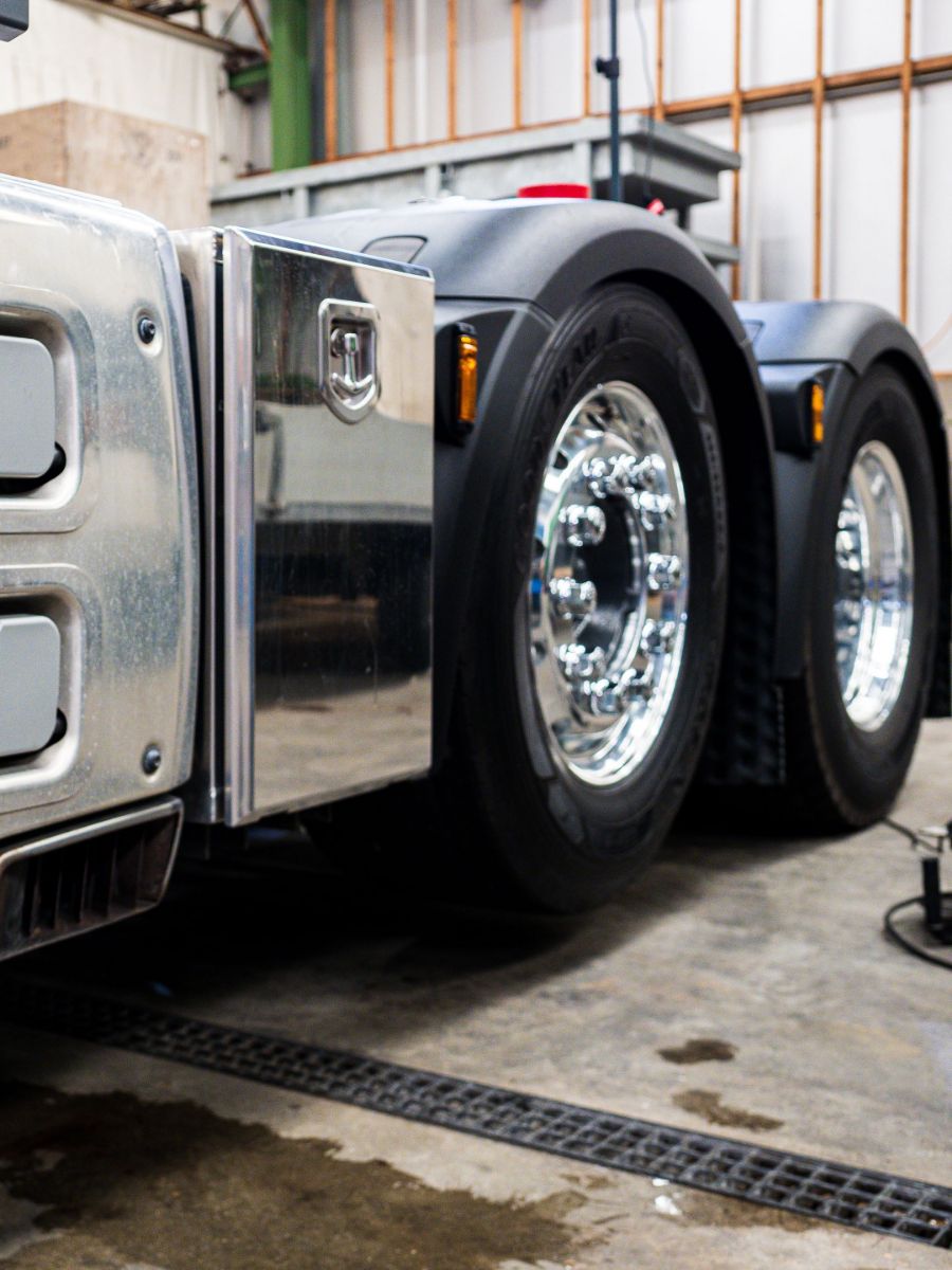 Drive axles and alloy wheels of a prime mover in a heavy vehicle workshop